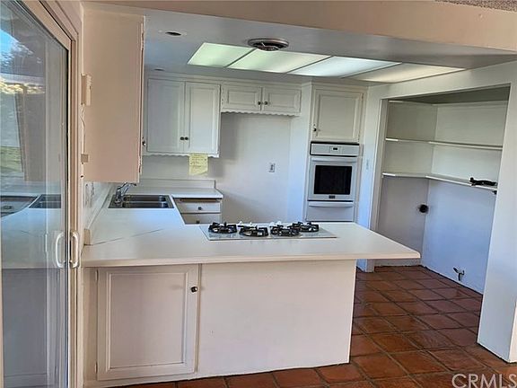 Bright, open kitchen with windows to back yard and separate laundry area with hook ups.