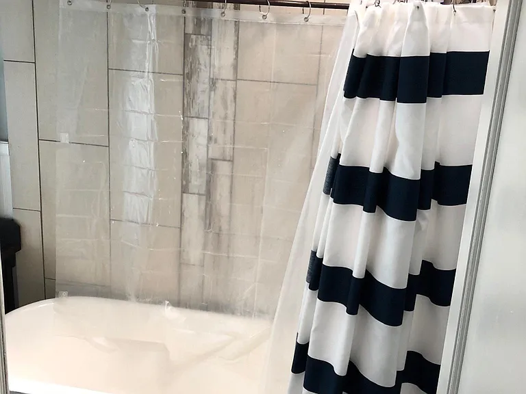 full bathroom, bathtub has waterfall shower