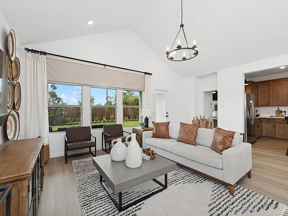 Great room with vaulted ceilings and chandelier