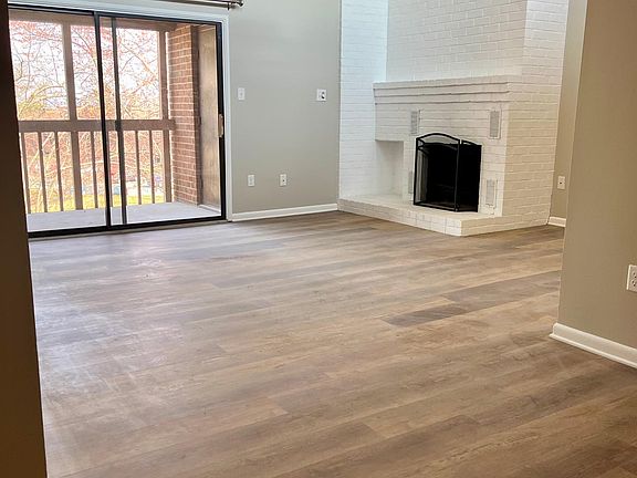 Dining room view to living room with vaulted ceilings