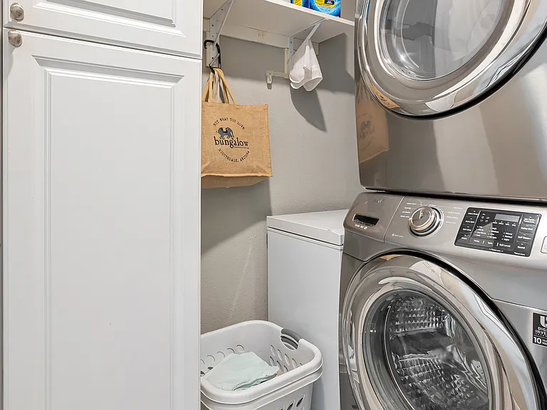 Laundry room with stacked Samsung washer and dryer and pantry storage