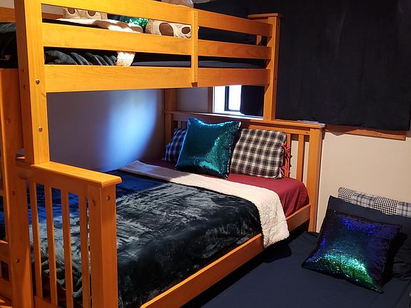 Bedroom #3 downstairs. Shown with double bed bunk and single trundle pulled out and there's still space in the room. Large closet.