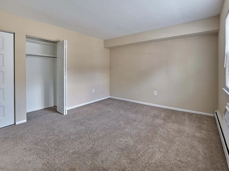 Bright bedroom with large closet and plush carpet at 42 West Apartments in Merchantville, NJ