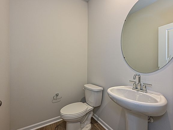 The half bathroom is conveniently located on the first floor for guests.