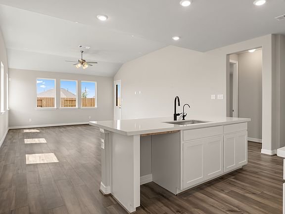 The center island features an extended counterspace perfect for a breakfast bar and overlooks the fa