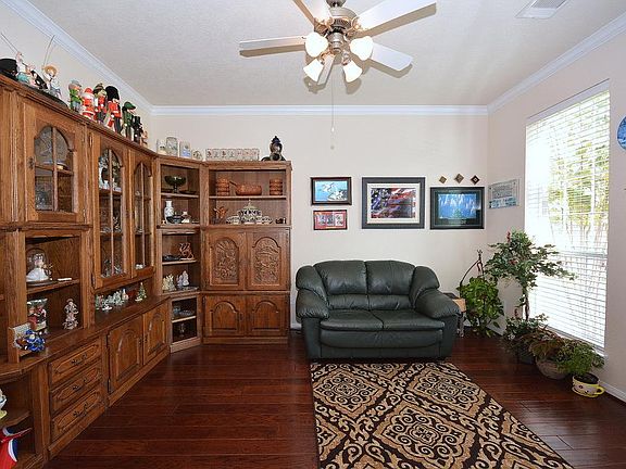 The study has an upgraded 5" plank hardwood floor, crown molding and ceiling fan