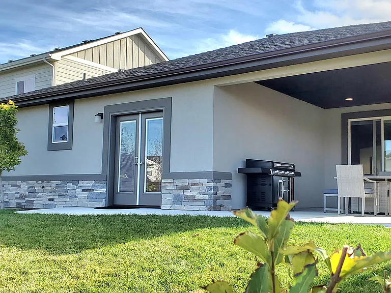 COVERED PATIO WITH WITH FRENCH DOORS TO BACKYARD FROM MASTER BEDROOM.