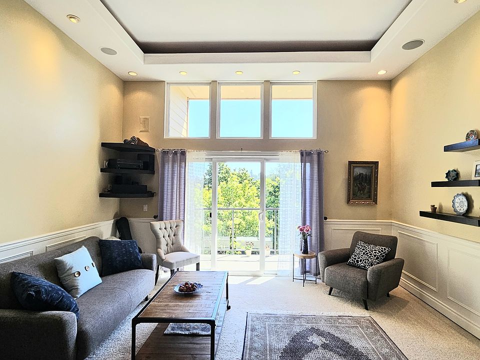 Living room with large windows and sliding door to the deck.
