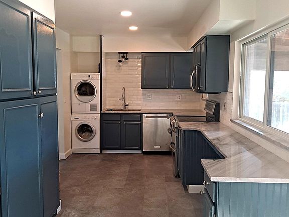 Kitchen with laundry. Stainless steel appliances