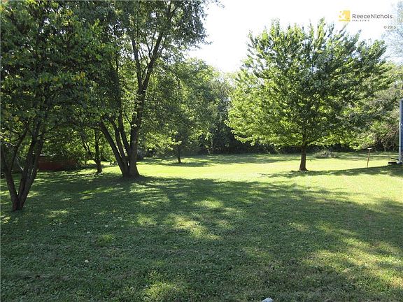 Spacious lot sits beside house - probably can be subdivided - or used for garden or play or peaceful setting