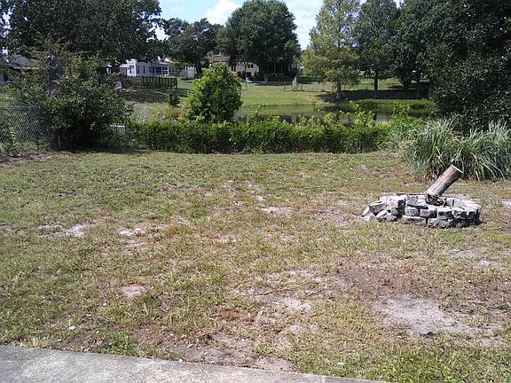 Fenced backyard overlooks retention pond