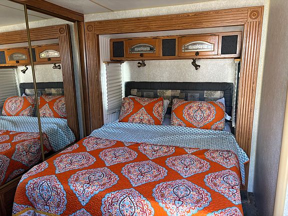 Bedroom one has chest of drawers and a large closet with sliding glass doors