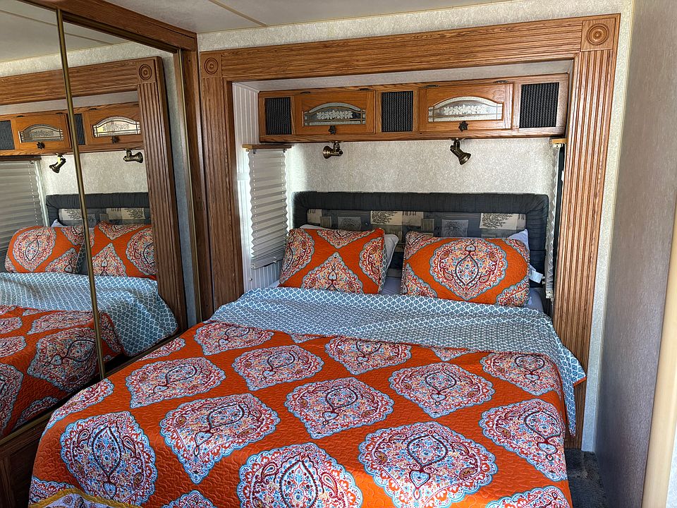Bedroom one has chest of drawers and a large closet with sliding glass doors