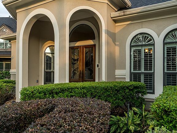 Beautiful covered front porch and flower beds.