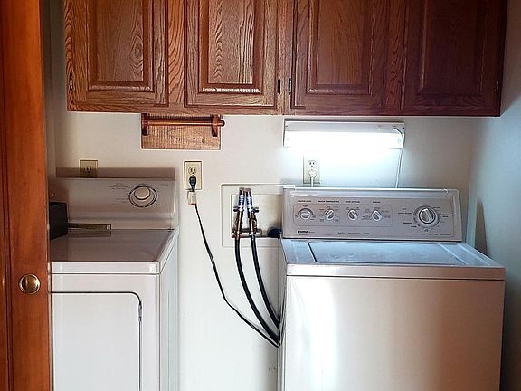 1st floor laundry with storage above and room for vacuum and mops.