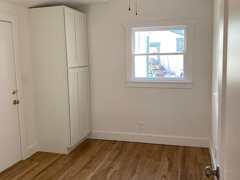 MASTER BEDROOM WITH NEWLY INSTALLED CLOSET, HARDWOOD FLOORS, WINDOW A/C AND CEILING FAN