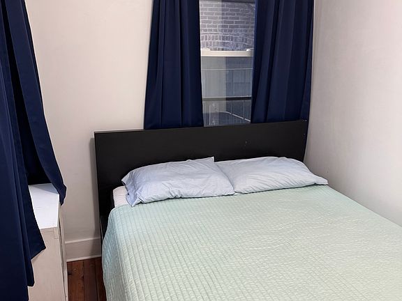 Back bedroom with queen sized bed and the closet is on the opposite wall.