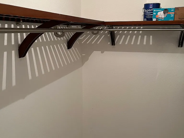 Walk-in closet with shelving and hang space.