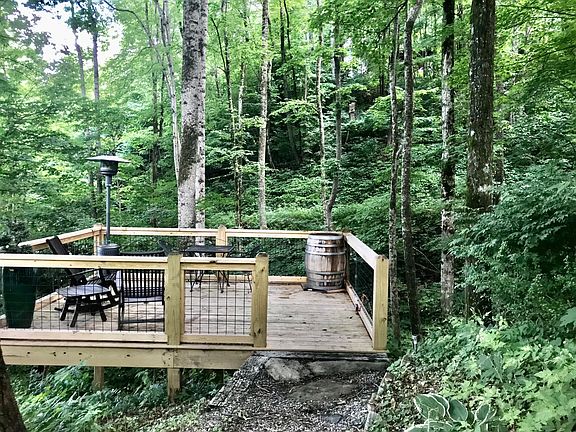 creek-side deck with space heater for chilly evenings