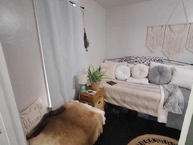 View of front wall from front entry/ Previous resident's furnished view - unit is rented unfurnished