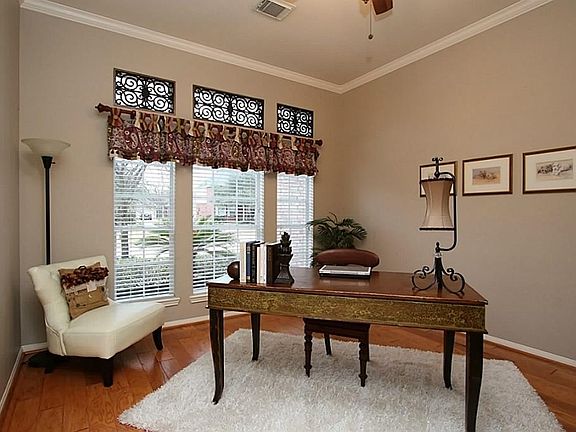 Hand scraped wood floors, crown molding and faux iron works in the transom windows add that custom touch.