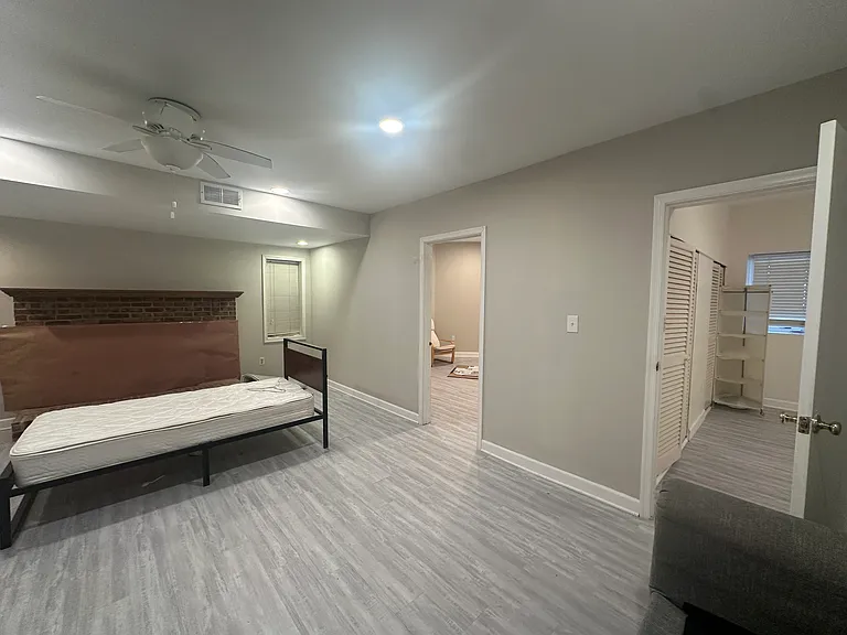 Two bedrooms and a spacious living room with a fireplace.