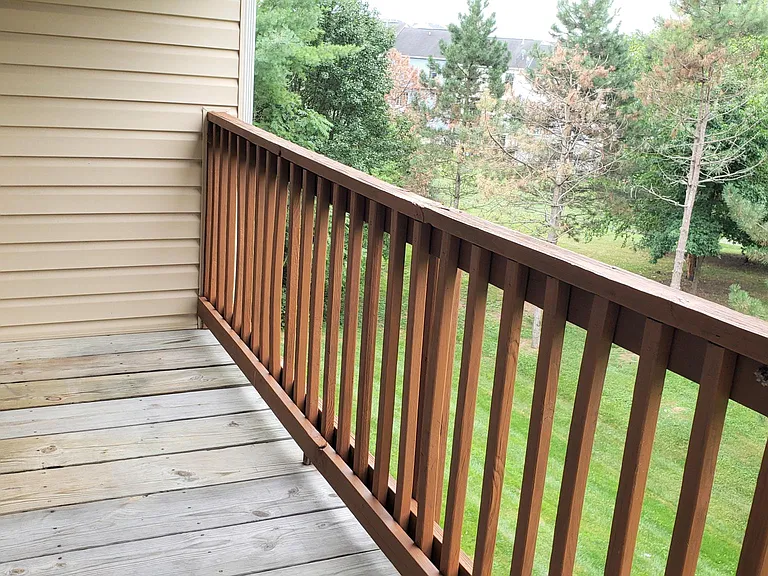 Private back deck, overlooking trees and large grassy yard