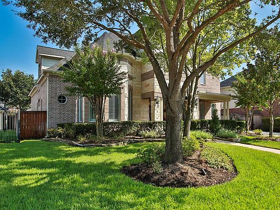 Recently elevated trees still provide shade. Gate offers keyless entry pad. Sidewalk to personal mail box.