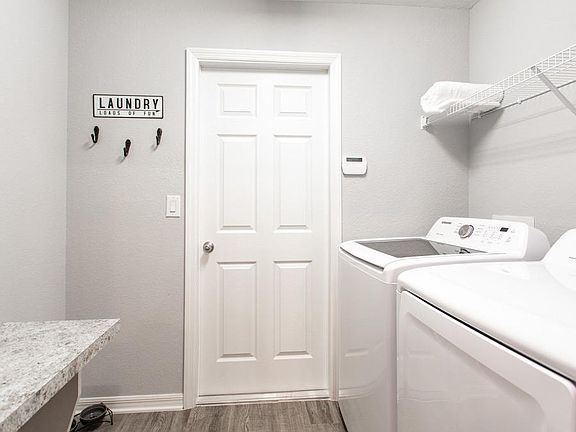 Laundry room with convenient drop-zone for additional organization and storage - New home for sale i