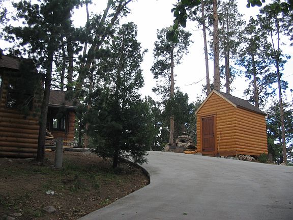 New concrete driveway and log shed