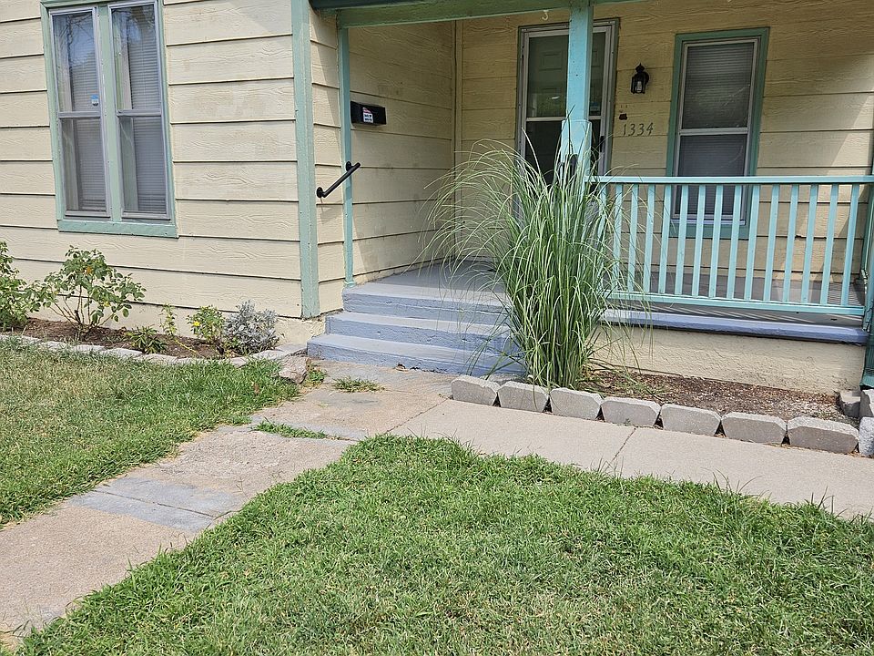 Front view of home; porch has hand rails on both sides of steps.