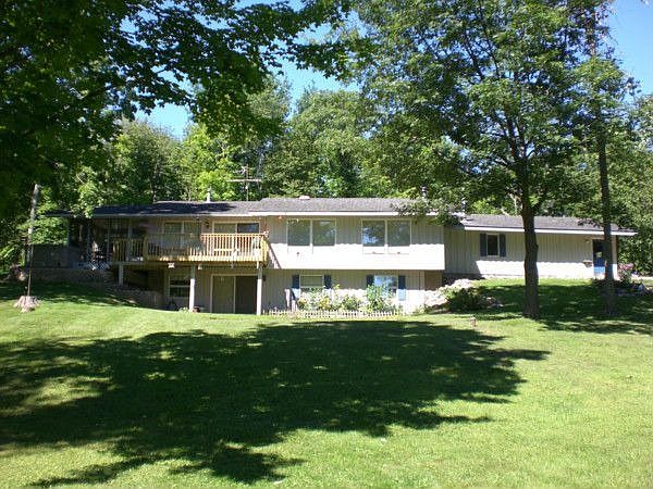 Perfectly situated on 5+ wooded acres.