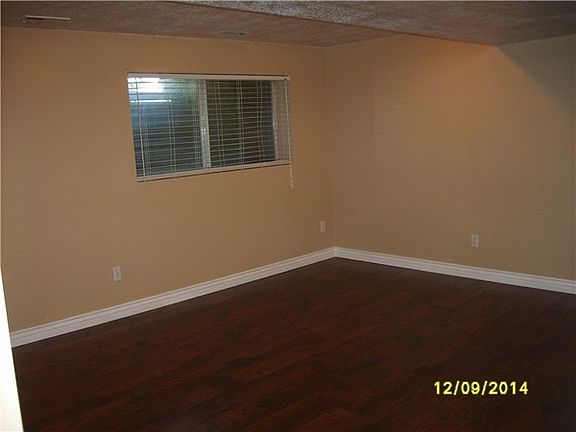 Living Room with big window and laminate wood flooring.