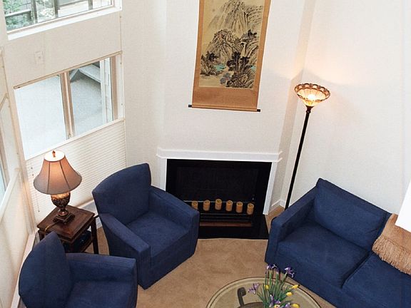 living room space with fireplace as seen from loft area