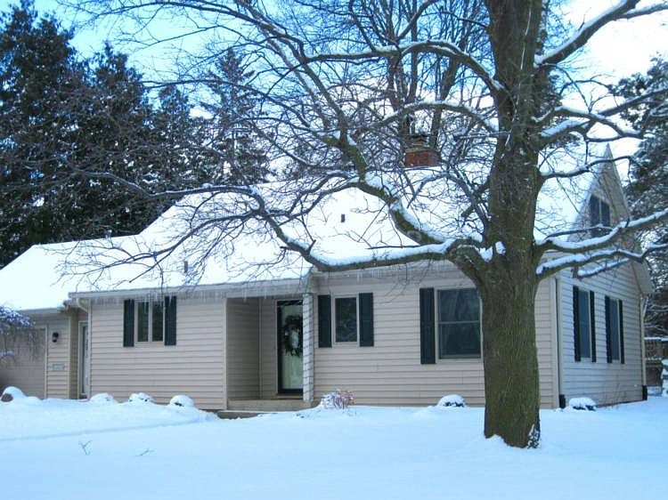 Enjoy the warmth of the gorgeous fireplace and the natural wood floors that enhance this timeless ca
