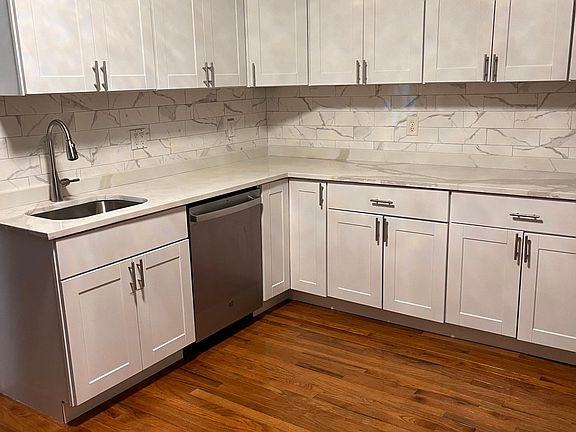 Spacious eat-in-kitchen with crown moldings, and new light fixture.