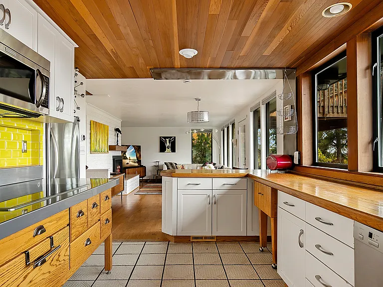 Open concept living, dining and kitchen area with a full wall of windows for incredible views and natural light.