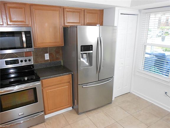 Kitchen is bright and spacious with lots of storage.