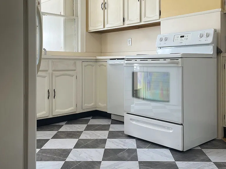 Kitchen with stove and refrigerator