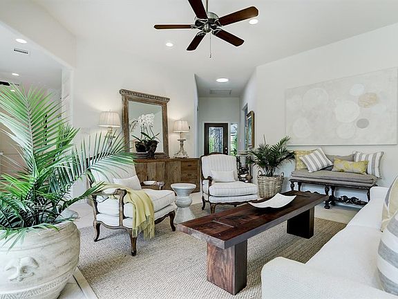 VIEW OF THE DINING OR FORMAL LIVING AREA WITH THE FOYER AND ACCESS TO 2 SPARE BEDROOMS IN THE BACKGROUND.