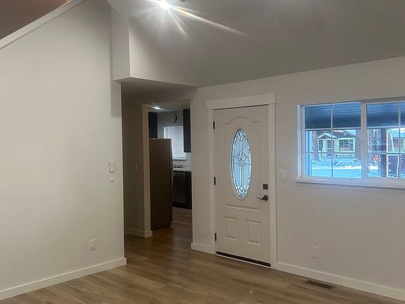 Living room facing front door and kitchen
