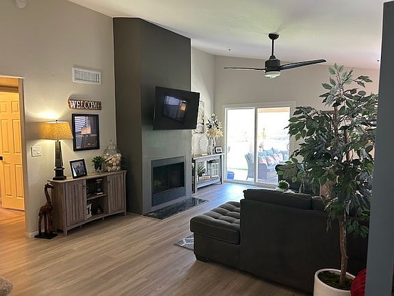 Spacious living room with wood burning fireplace and sliding doors to the backyard