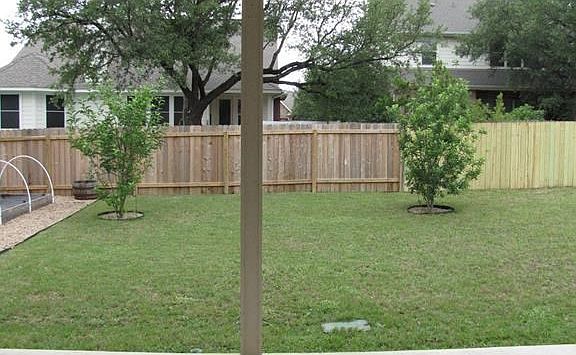 New fence (Oct 2015) on back left, and new fence on back right (May 2016). Granny Smith apple trees for a flavorful treat.
