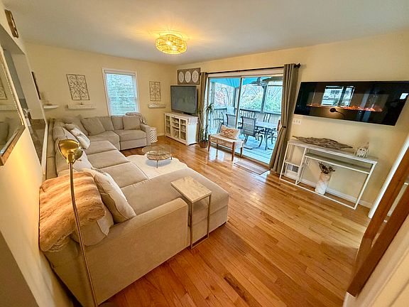 Family room with sliding glass doors leading to screened-in porch. Open to kitchen to pass through drinks & snacks. TV can be seen from dining area & kitchen. Laundry room access to the right & full bathroom. Half bath located where picture was taken.