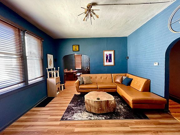 Living room; newly painted, new floors, light fixture.
