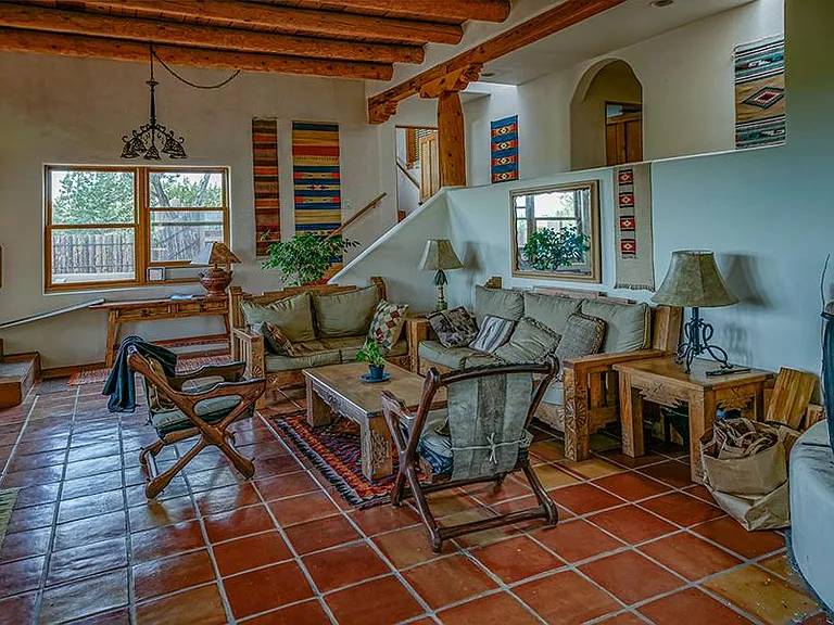 Living room with 12 ft ceilings, southern views and wood burning fireplace. Fully furnished.