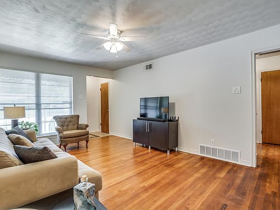 Living room staged towards front door and hallway