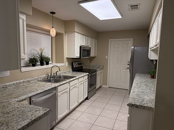 Galley Kitchen - Includes Refrigerator and all stainless steel appliances.