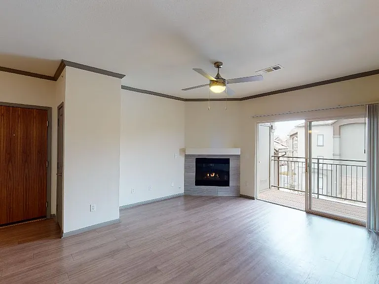 Apartment dining and living room with wood-style flooring.