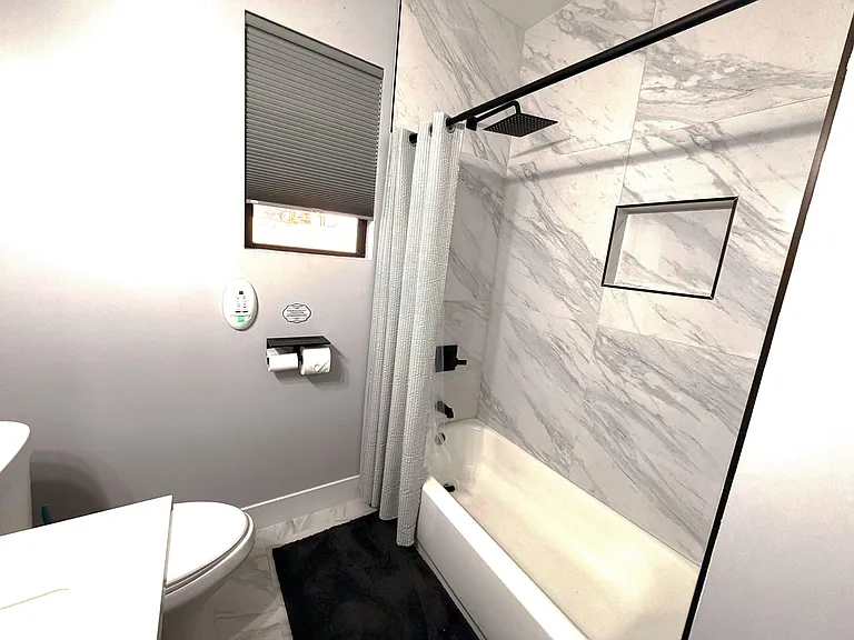 Fully updated with new tile, rain fall shower head, double toilet paper roll holder with mini-shelf